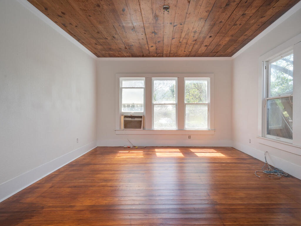 316 South Ave C, Unit B Elgin, TX 78621 - Photo 9 of 14 a view of an empty room with wooden floor and a window