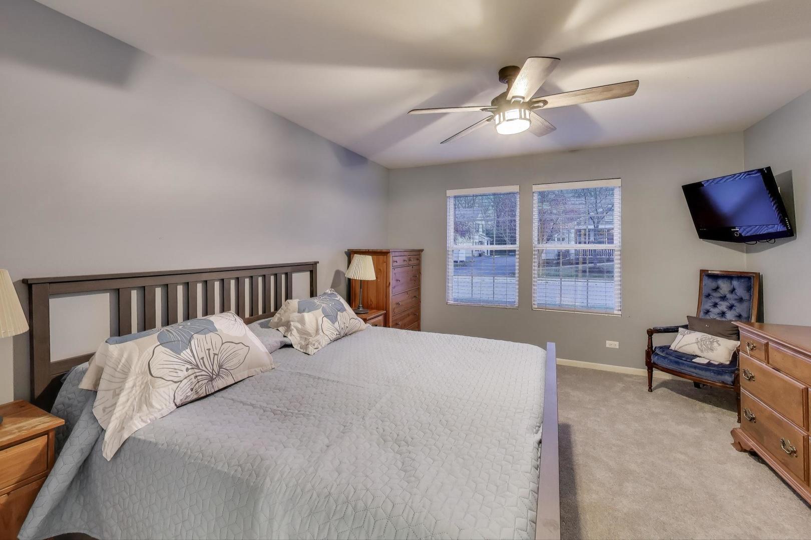 104 Waterbury Circle Oswego, IL 60543 - Photo 12 of 23 a bedroom with a bed and window