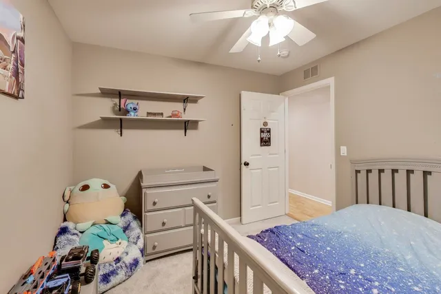 a view of a hallway to a livingroom with furniture
