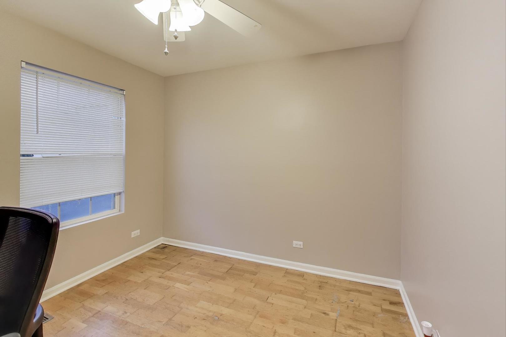 104 Waterbury Circle Oswego, IL 60543 - Photo 17 of 23 an empty room with a chandelier fan
