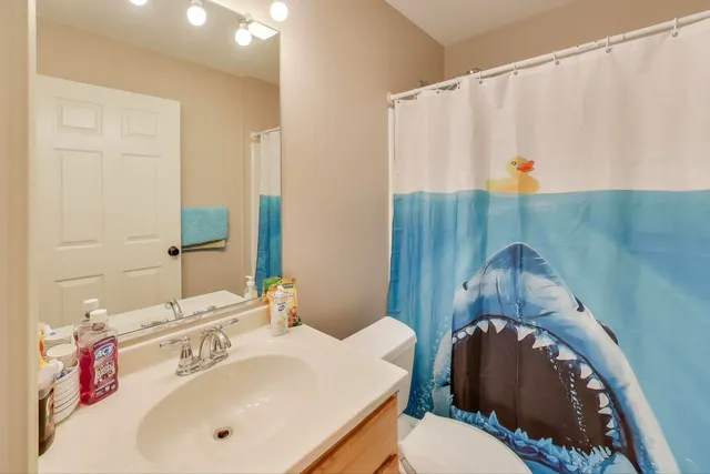 a bathroom with a sink vanity mirror and tub