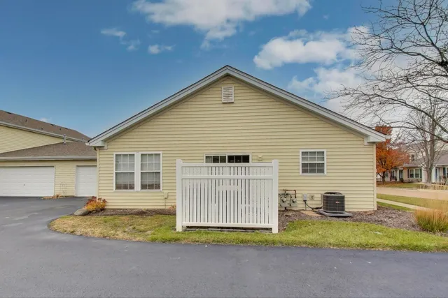 a view of a house with a yard and fence