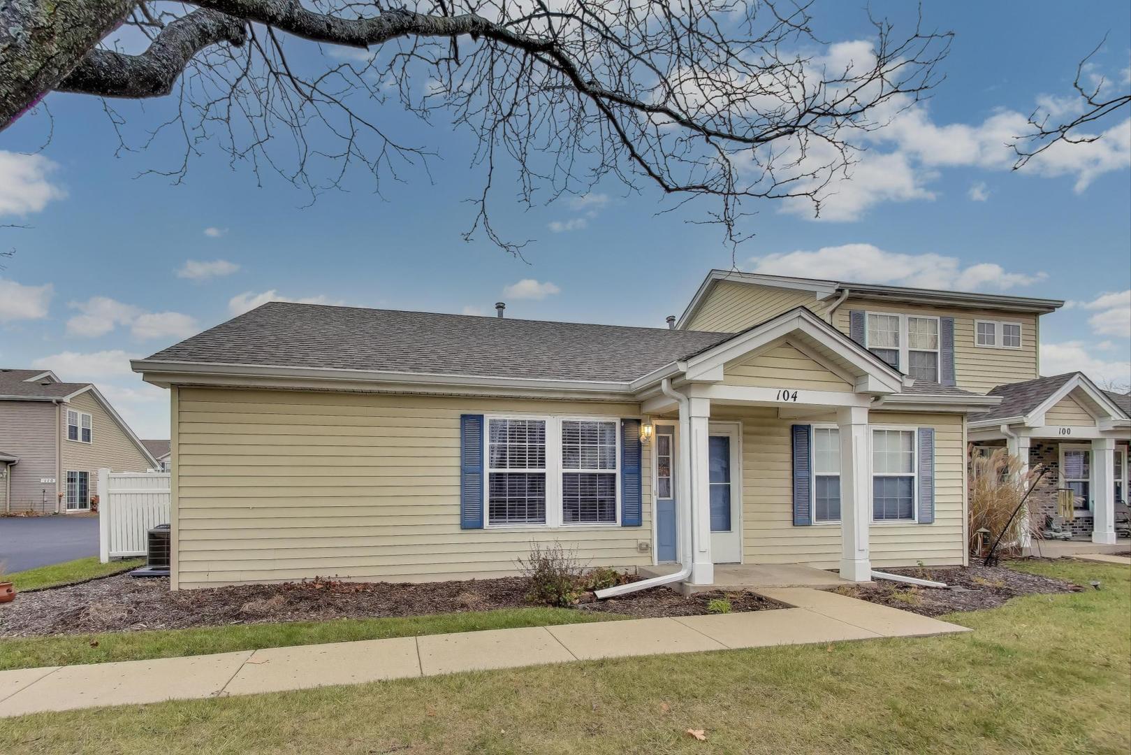 104 Waterbury Circle Oswego, IL 60543 - Photo 3 of 23 a front view of a house with a yard