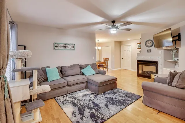 a living room with furniture and a fireplace