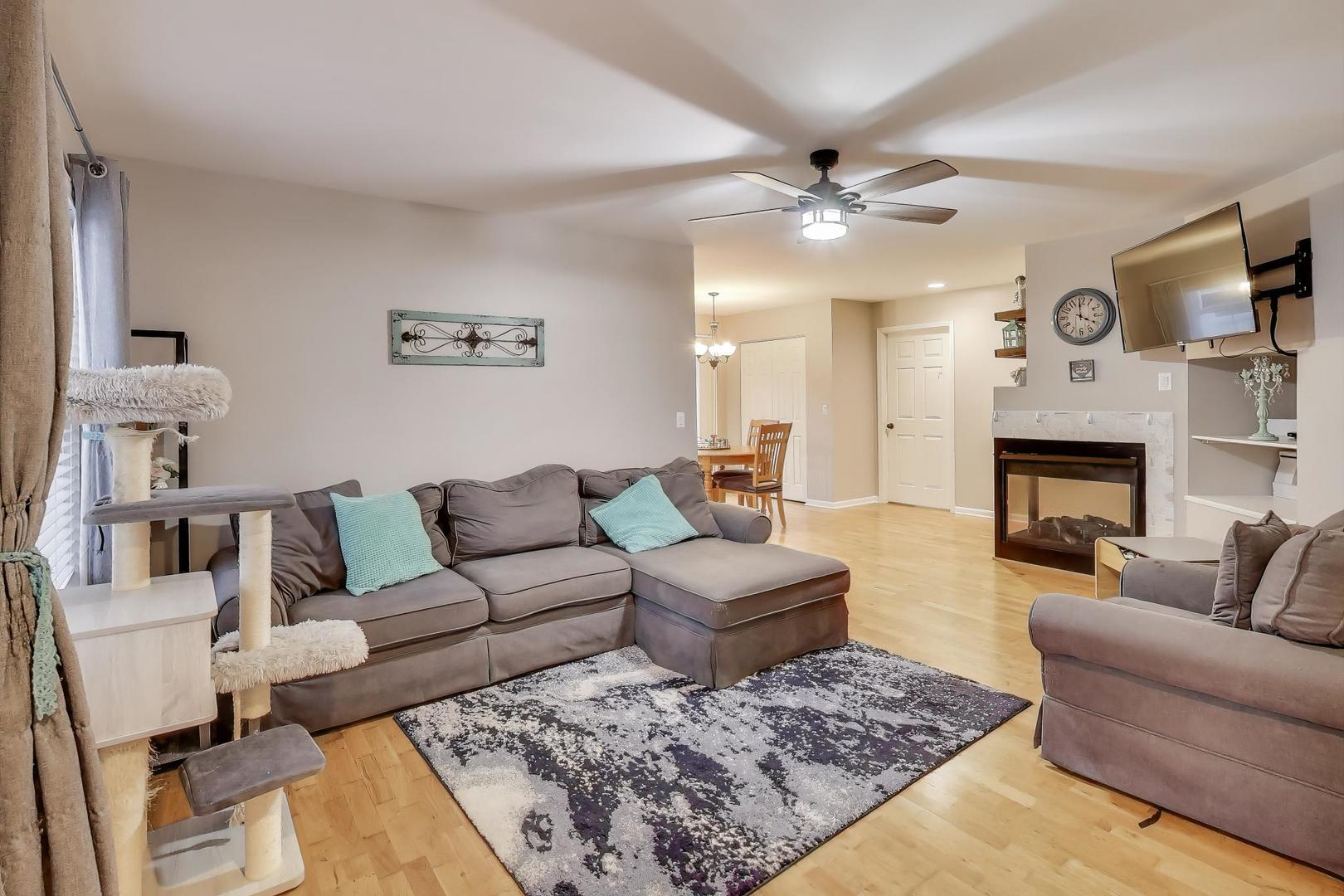 104 Waterbury Circle Oswego, IL 60543 - Photo 4 of 23 a living room with furniture and a fireplace