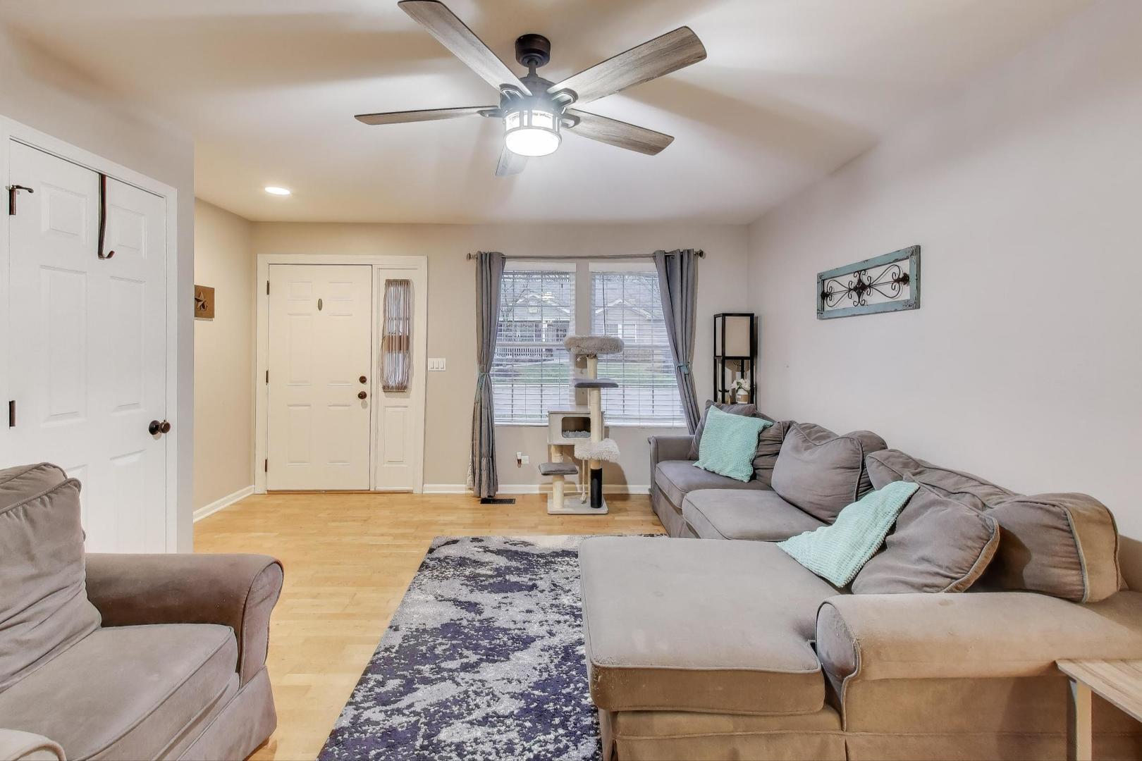 104 Waterbury Circle Oswego, IL 60543 - Photo 5 of 23 a living room with furniture and a couch