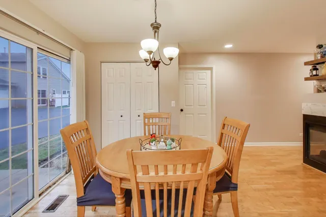 a view of a dining room with furniture wooden floor and a chandelier