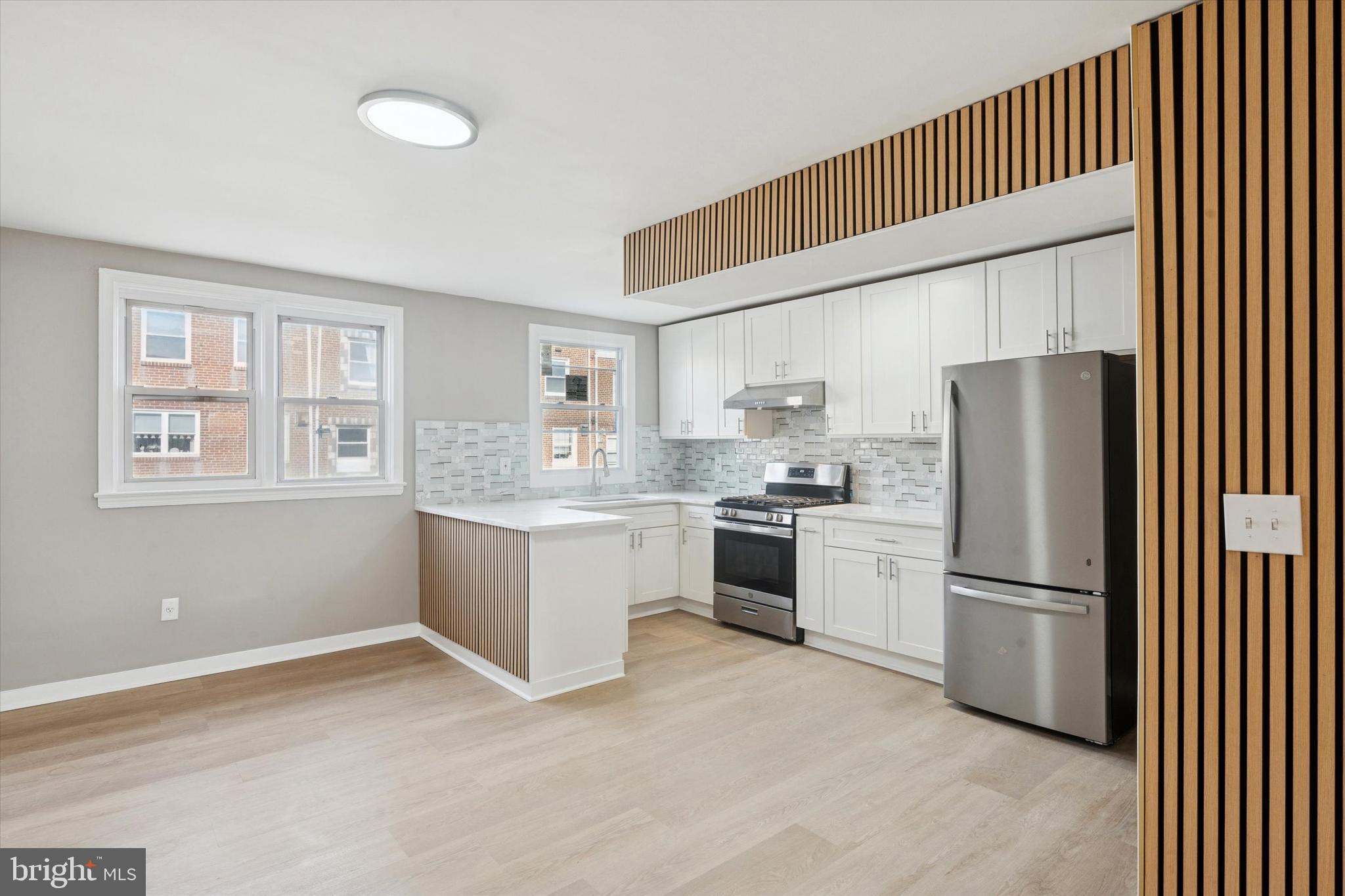 6340 Cardiff Street Philadelphia, PA 19149 - Photo 1 of 20 a kitchen with a refrigerator and cabinets