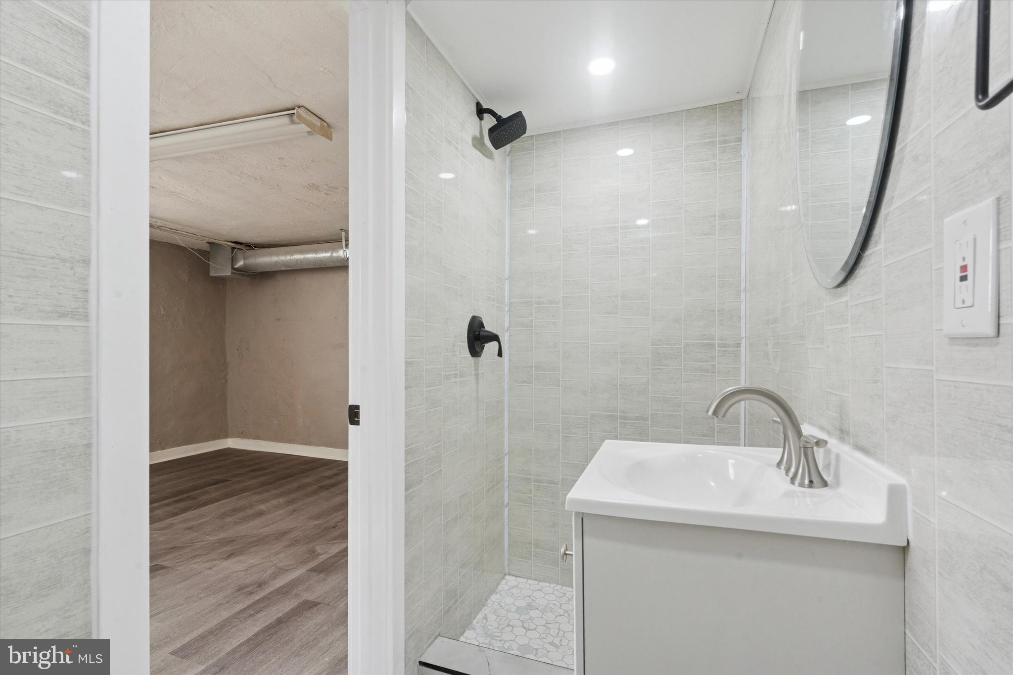 6340 Cardiff Street Philadelphia, PA 19149 - Photo 17 of 20 a bathroom with a sink mirror and shower