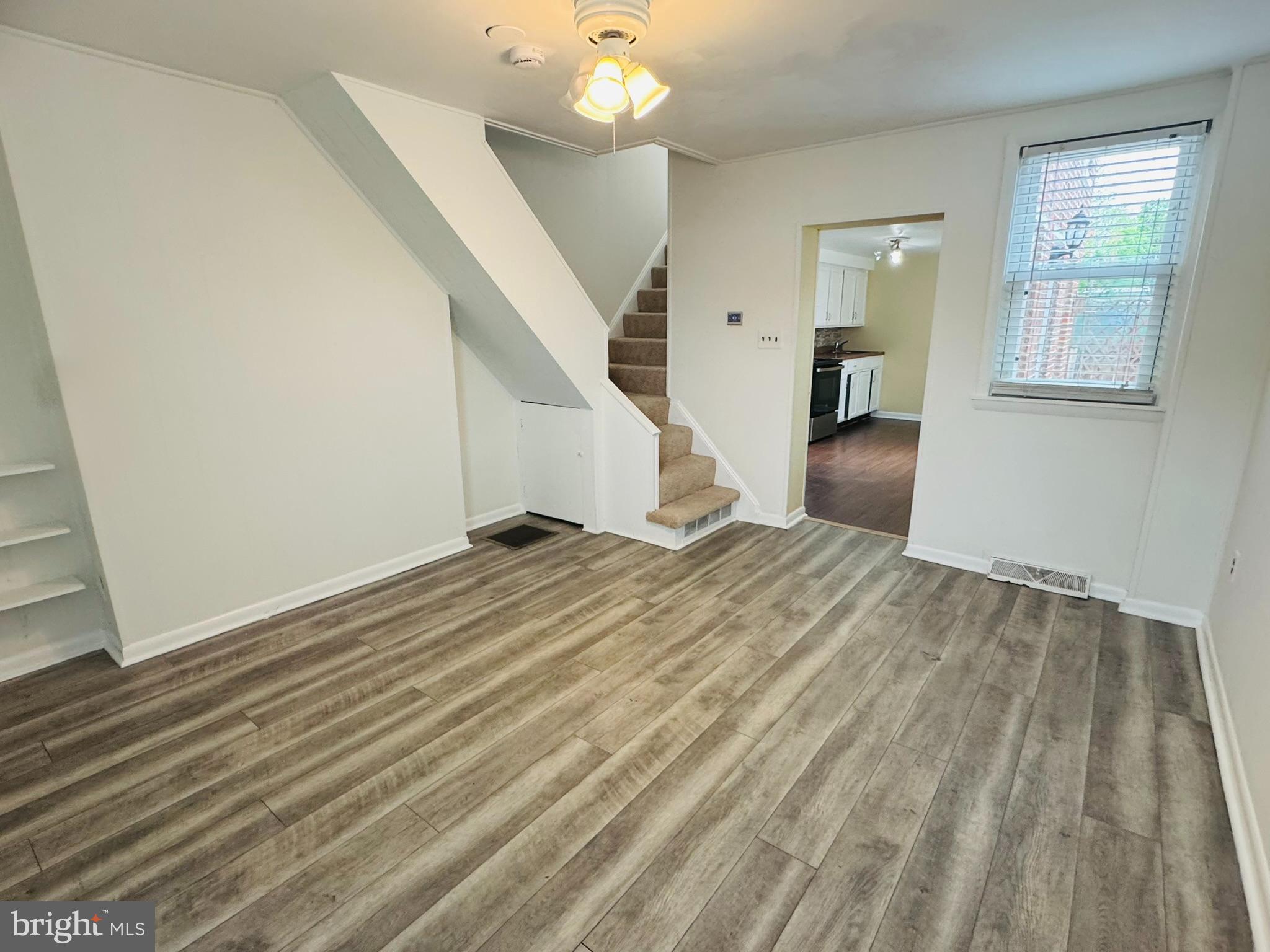 25 Degrange Street Frederick, MD 21701 - Photo 5 of 19 a view of a livingroom with wooden floor and stairs