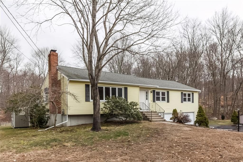 a view of a house with a yard covered in snow