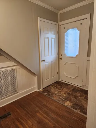 a view of a hallway with wooden floor