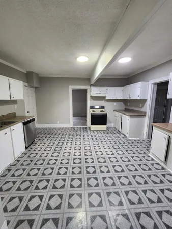 a bathroom with a sink a toilet a mirror and a shower