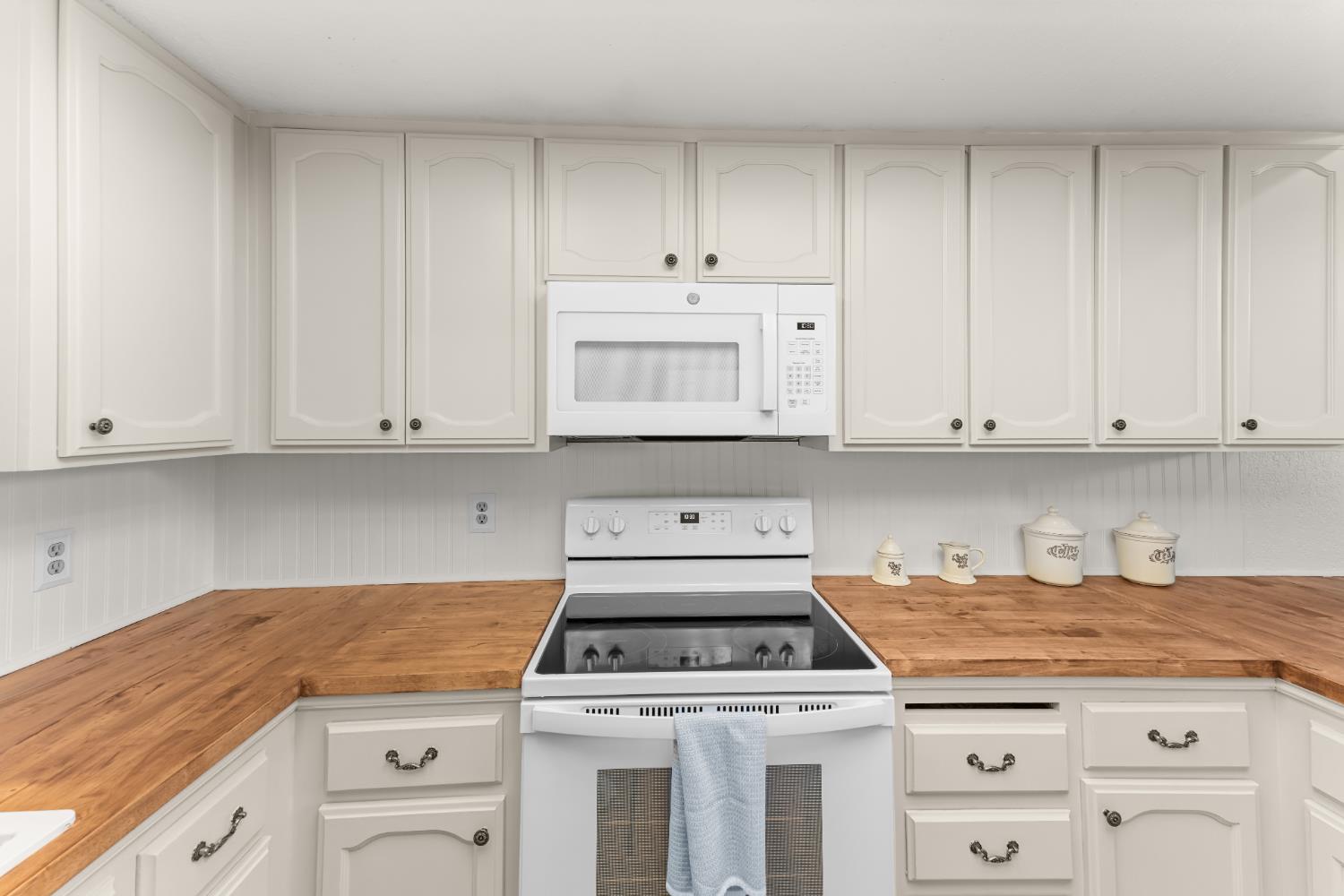 3395 Meadow Way Rocklin, CA 95677 - Photo 11 of 35 a kitchen with granite countertop white cabinets and white stove