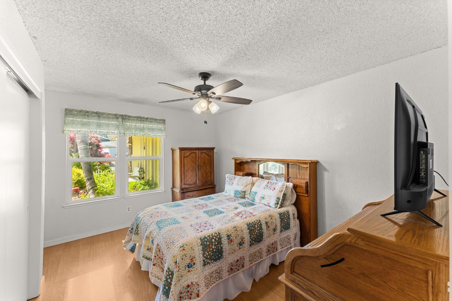 3395 Meadow Way Rocklin, CA 95677 - Photo 17 of 35 a bedroom with a bed and a flat tv screen on dresser