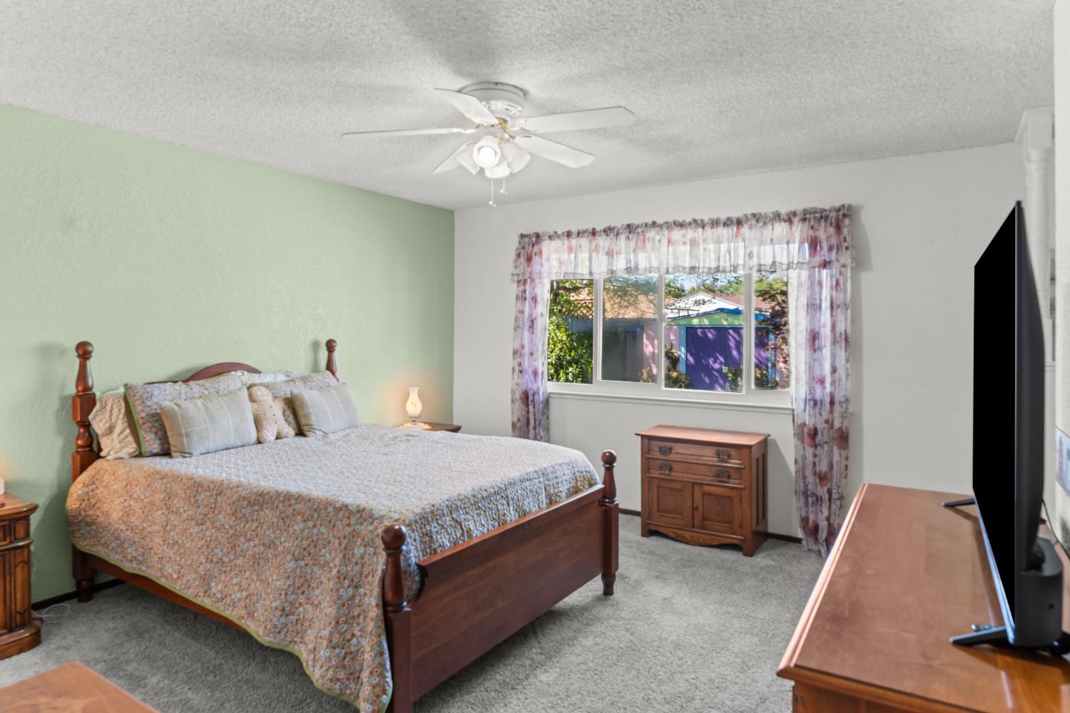 3395 Meadow Way Rocklin, CA 95677 - Photo 21 of 35 a bedroom with a bed and a flat tv screen on dresser