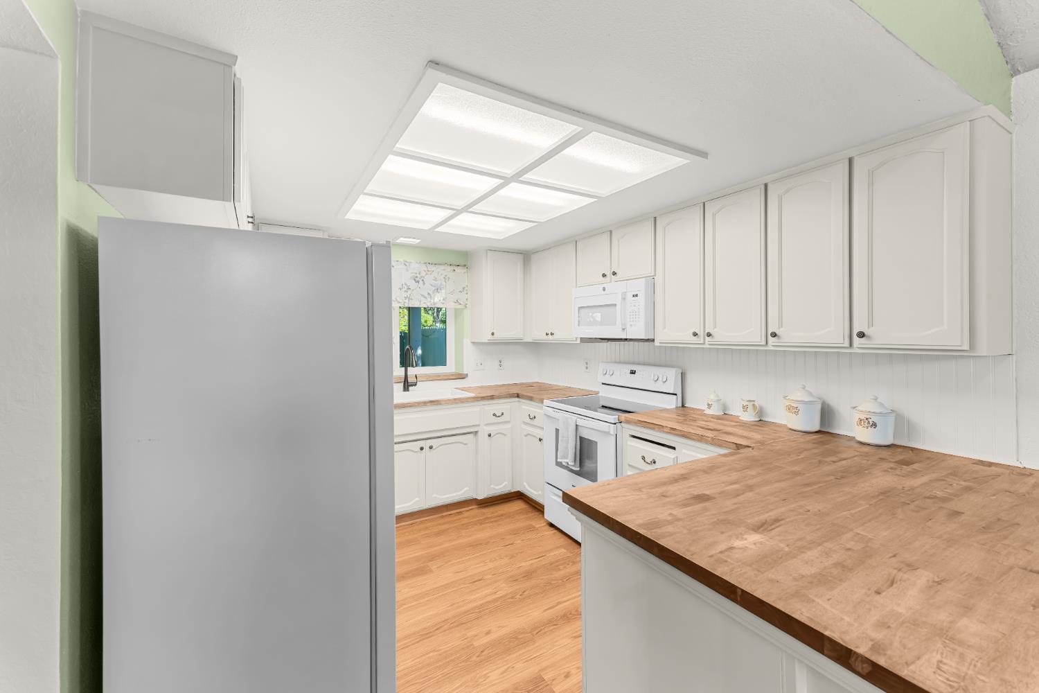 3395 Meadow Way Rocklin, CA 95677 - Photo 7 of 35 a kitchen with a sink window and cabinets