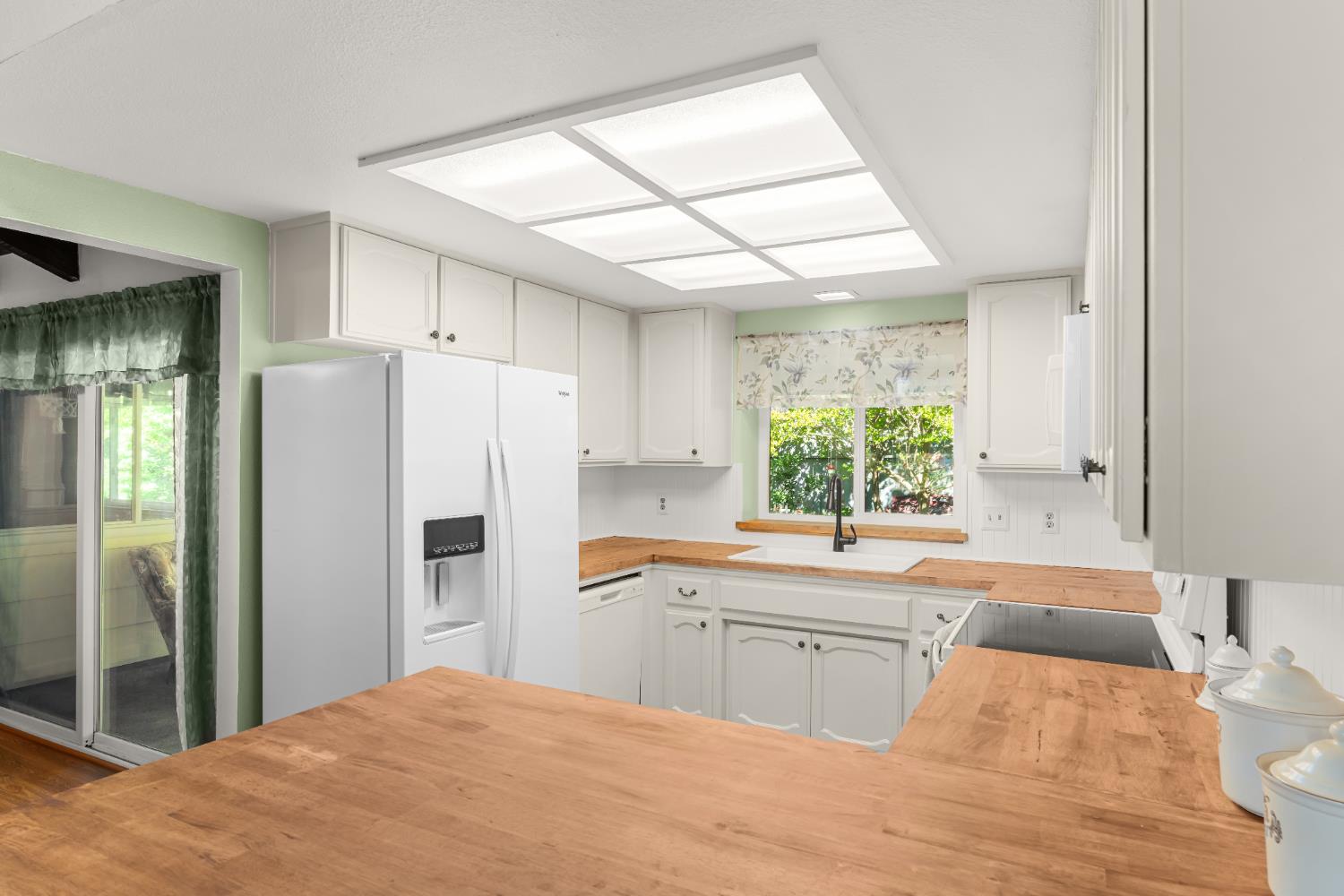 3395 Meadow Way Rocklin, CA 95677 - Photo 9 of 35 a kitchen with a sink a refrigerator and window
