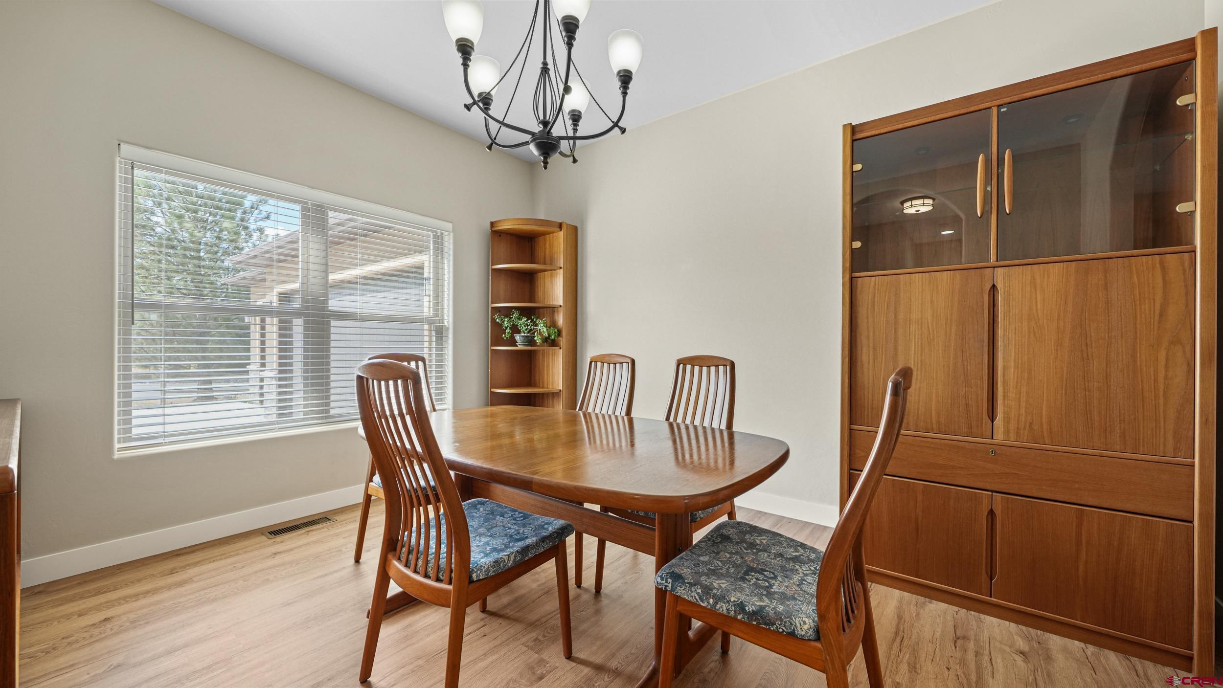 2042 Constitution Loop Montrose, CO 81401 - Photo 11 of 42 a dining room with furniture window and wooden floor