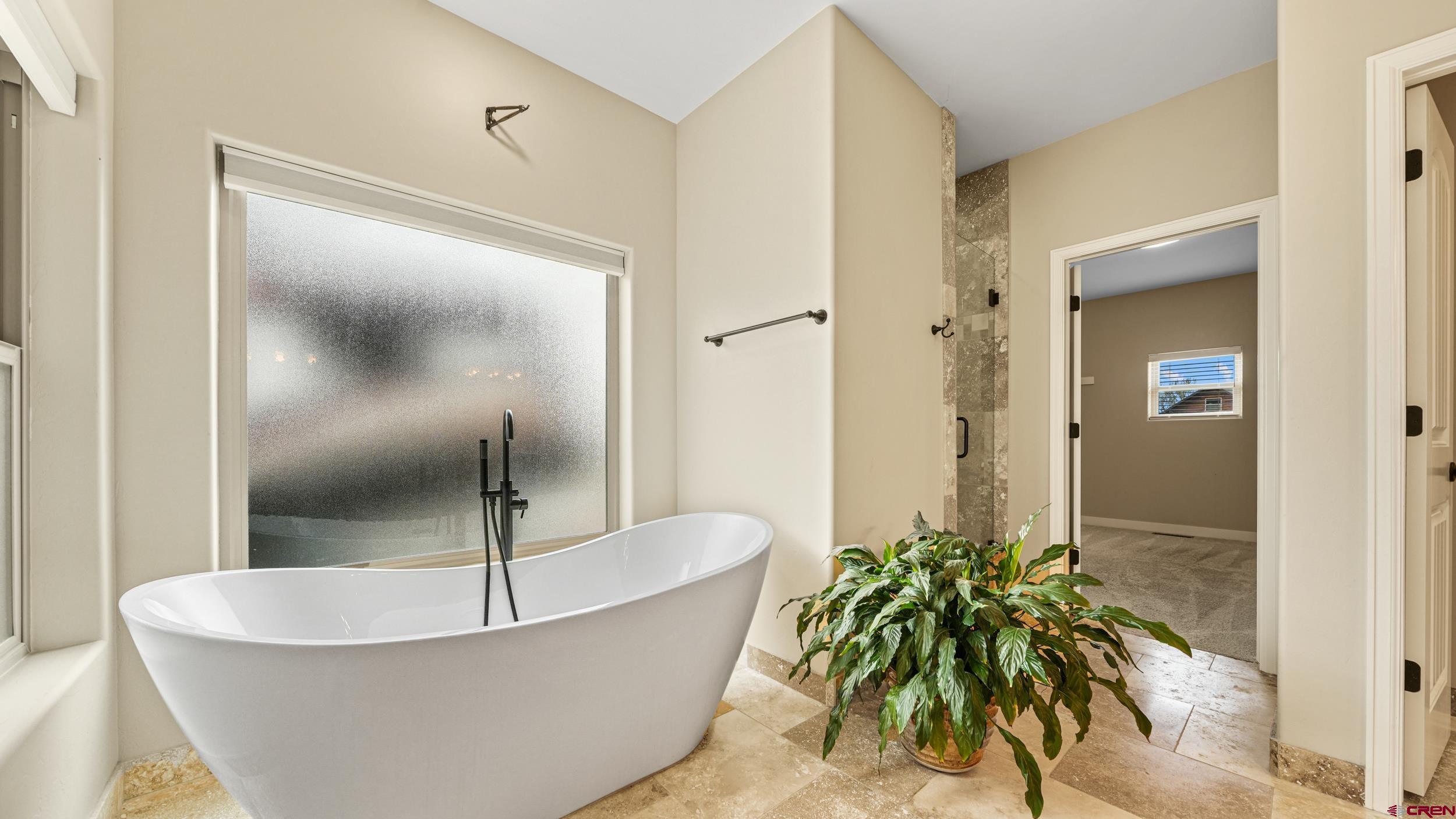 2042 Constitution Loop Montrose, CO 81401 - Photo 17 of 42 a bathroom with a bathtub and shower