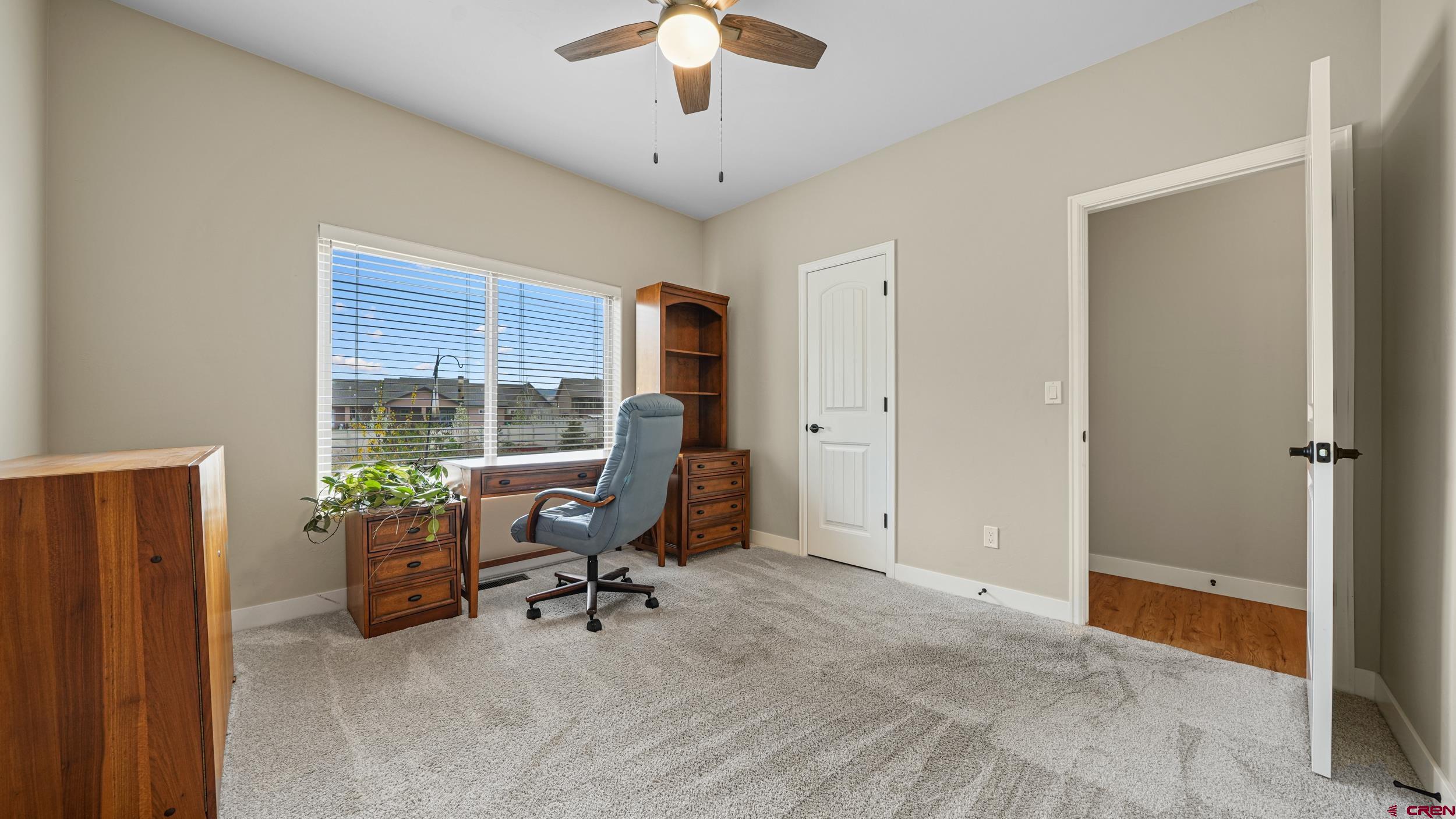 2042 Constitution Loop Montrose, CO 81401 - Photo 19 of 42 a view of a workspace with furniture and a window