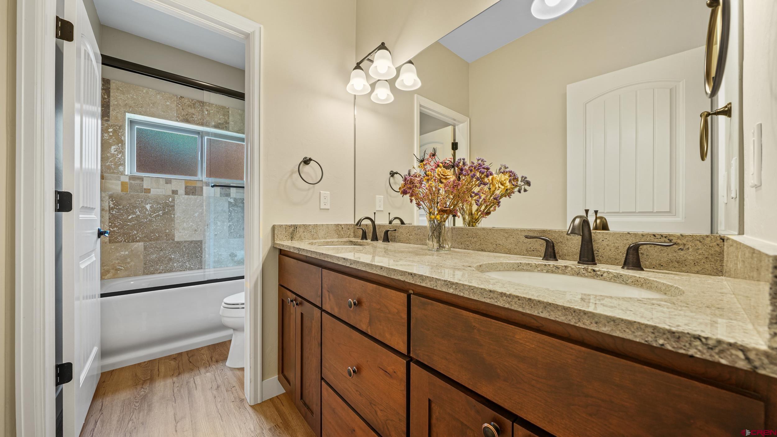 2042 Constitution Loop Montrose, CO 81401 - Photo 20 of 42 a bathroom with a granite countertop sink mirror and vanity