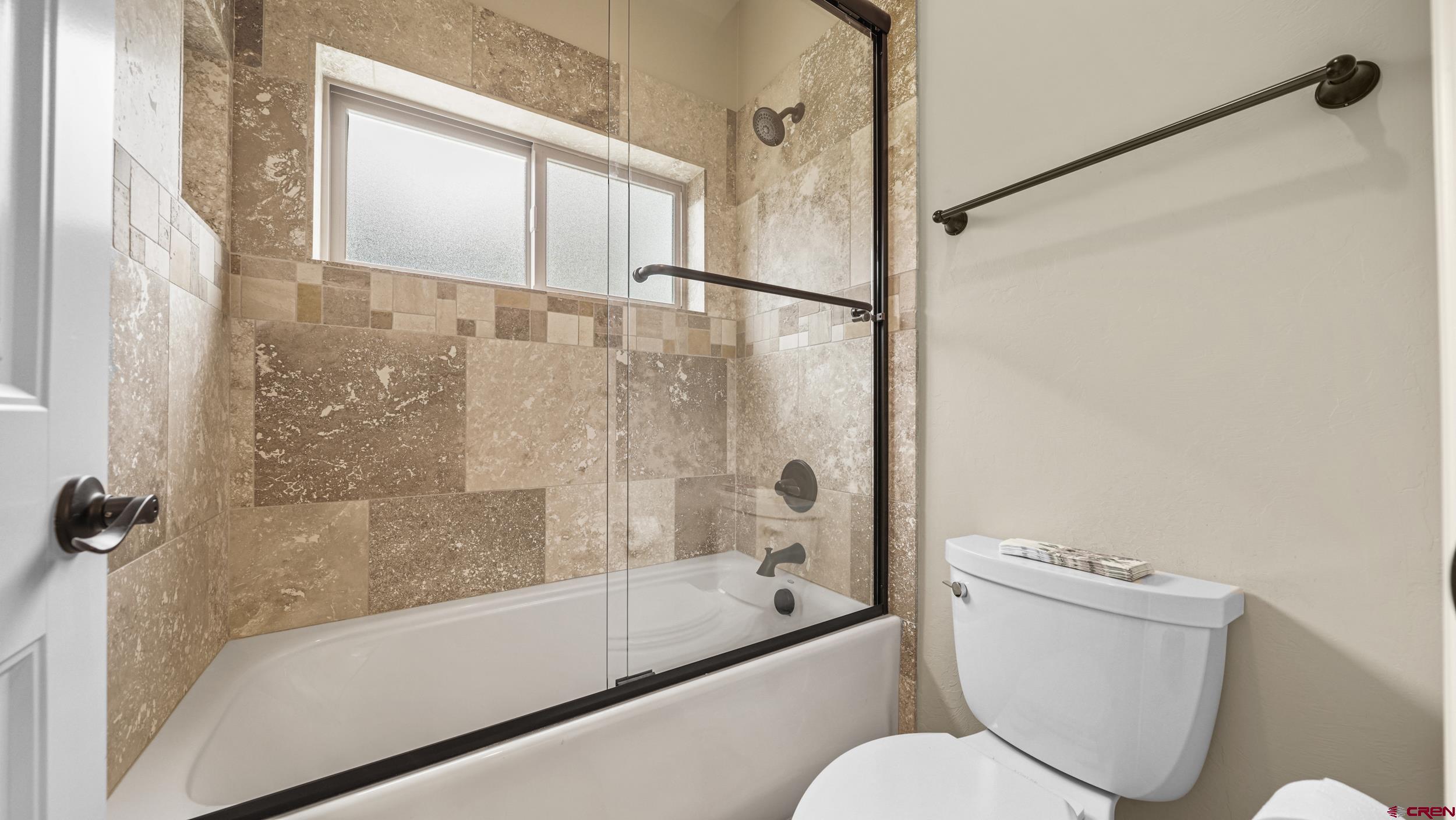 2042 Constitution Loop Montrose, CO 81401 - Photo 21 of 42 a bathroom with a granite countertop bathtub shower and toilet