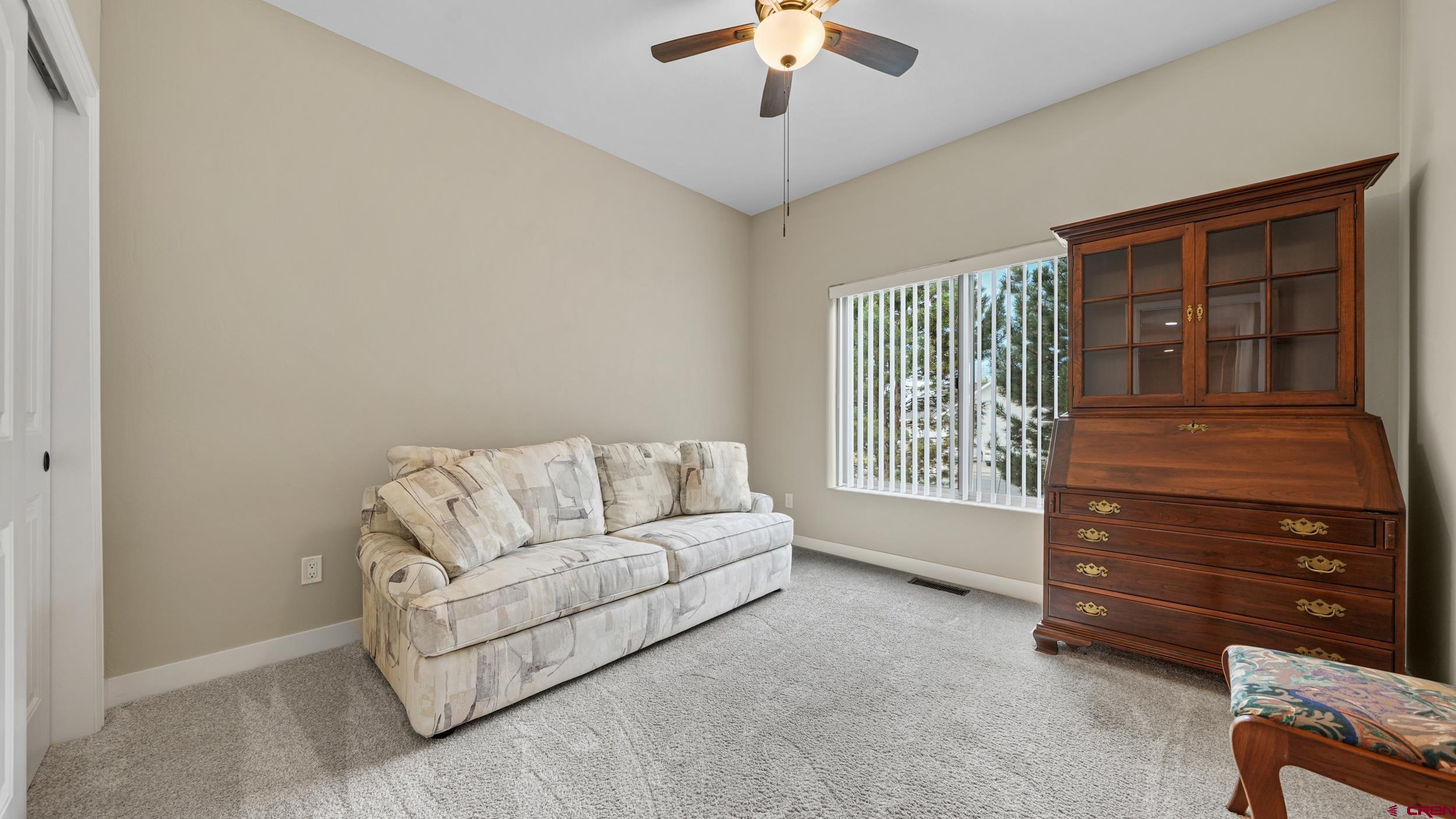 2042 Constitution Loop Montrose, CO 81401 - Photo 22 of 42 a living room with furniture and a window