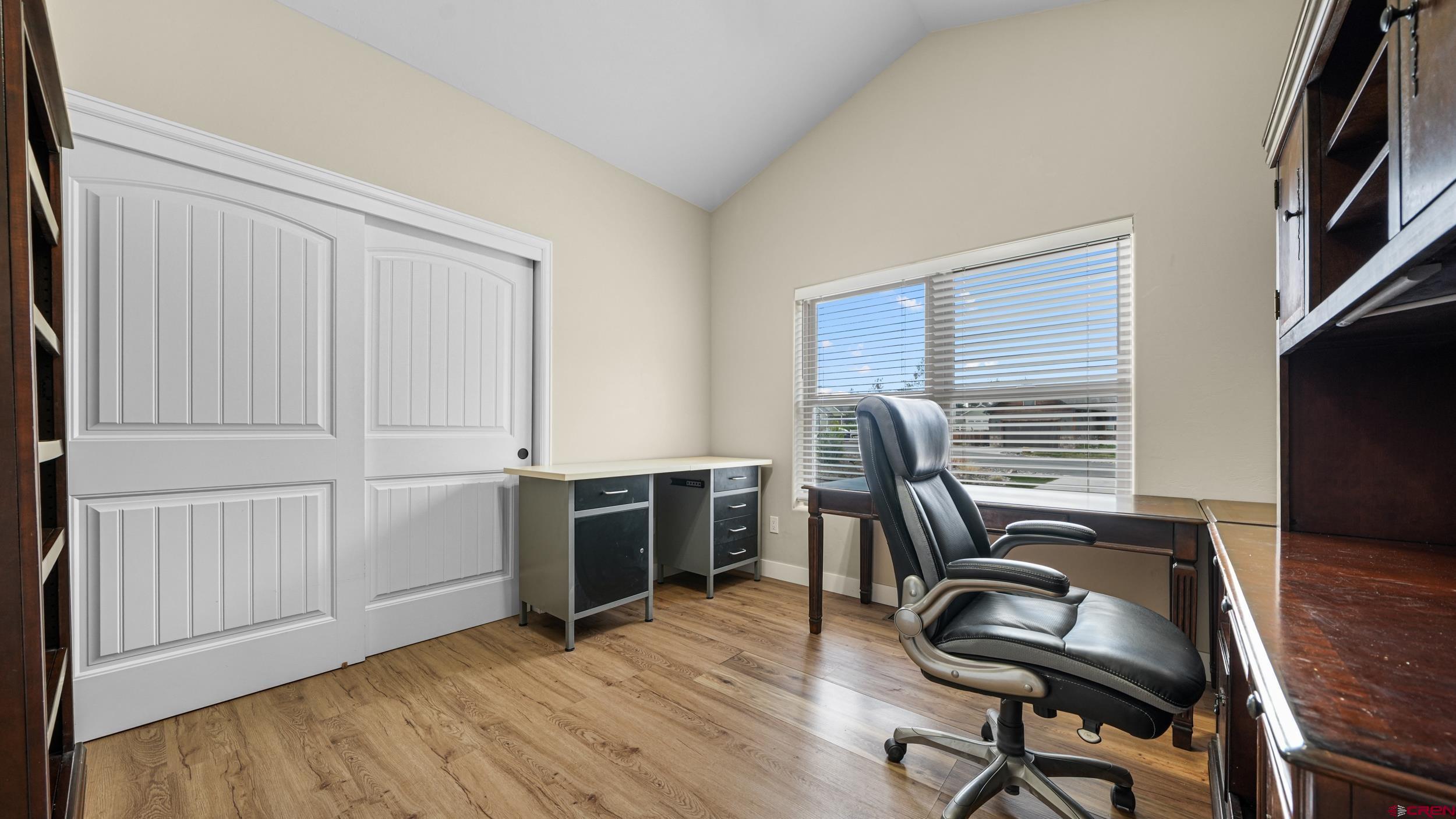 2042 Constitution Loop Montrose, CO 81401 - Photo 25 of 42 a view of a workspace with furniture and a window