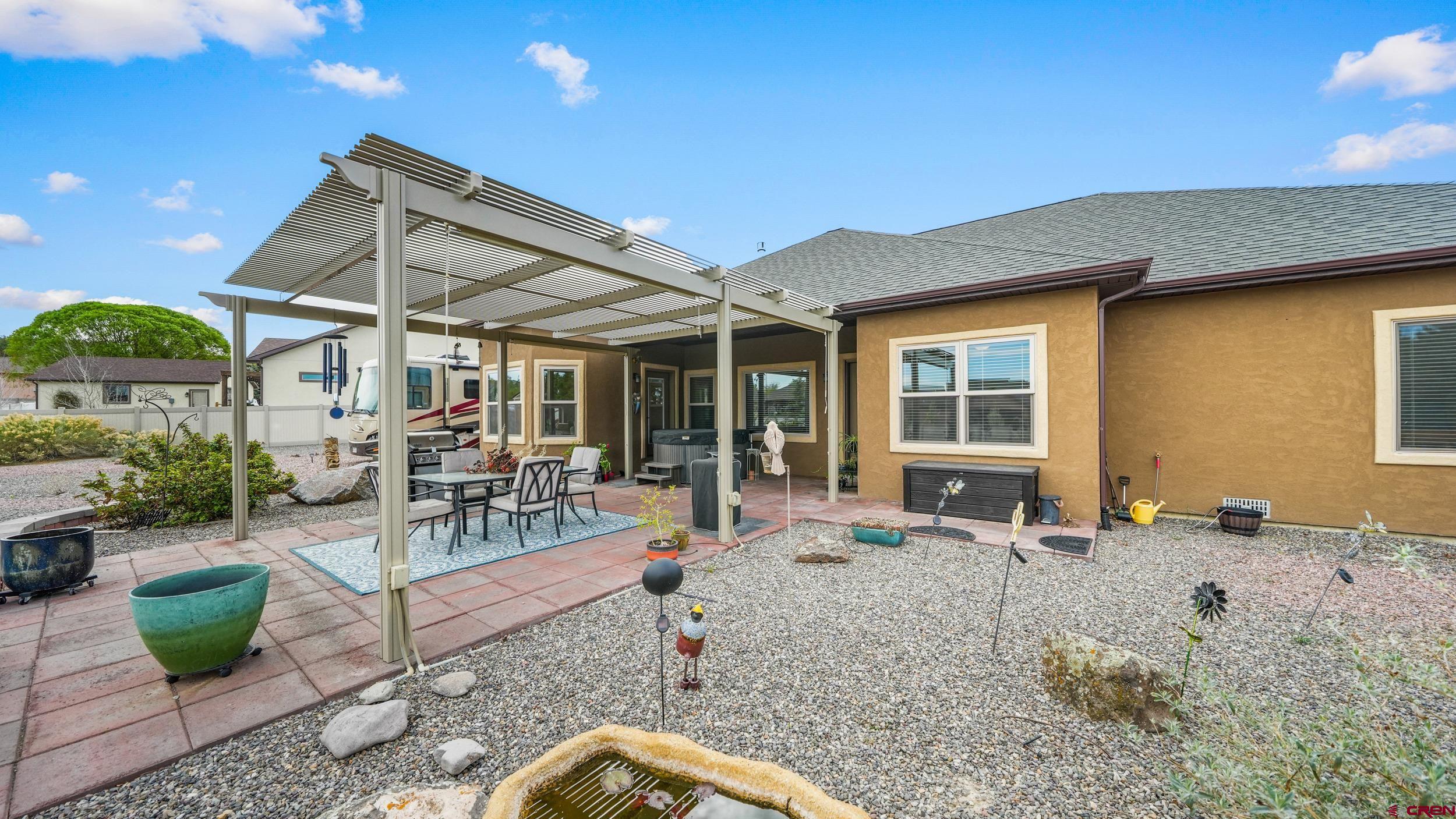 2042 Constitution Loop Montrose, CO 81401 - Photo 30 of 42 a view of a patio with couches chairs and potted plants