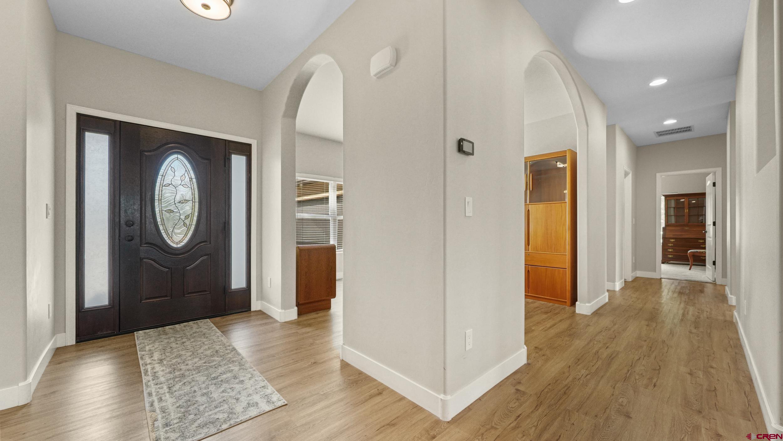 2042 Constitution Loop Montrose, CO 81401 - Photo 4 of 42 a view of a hallway with wooden floor