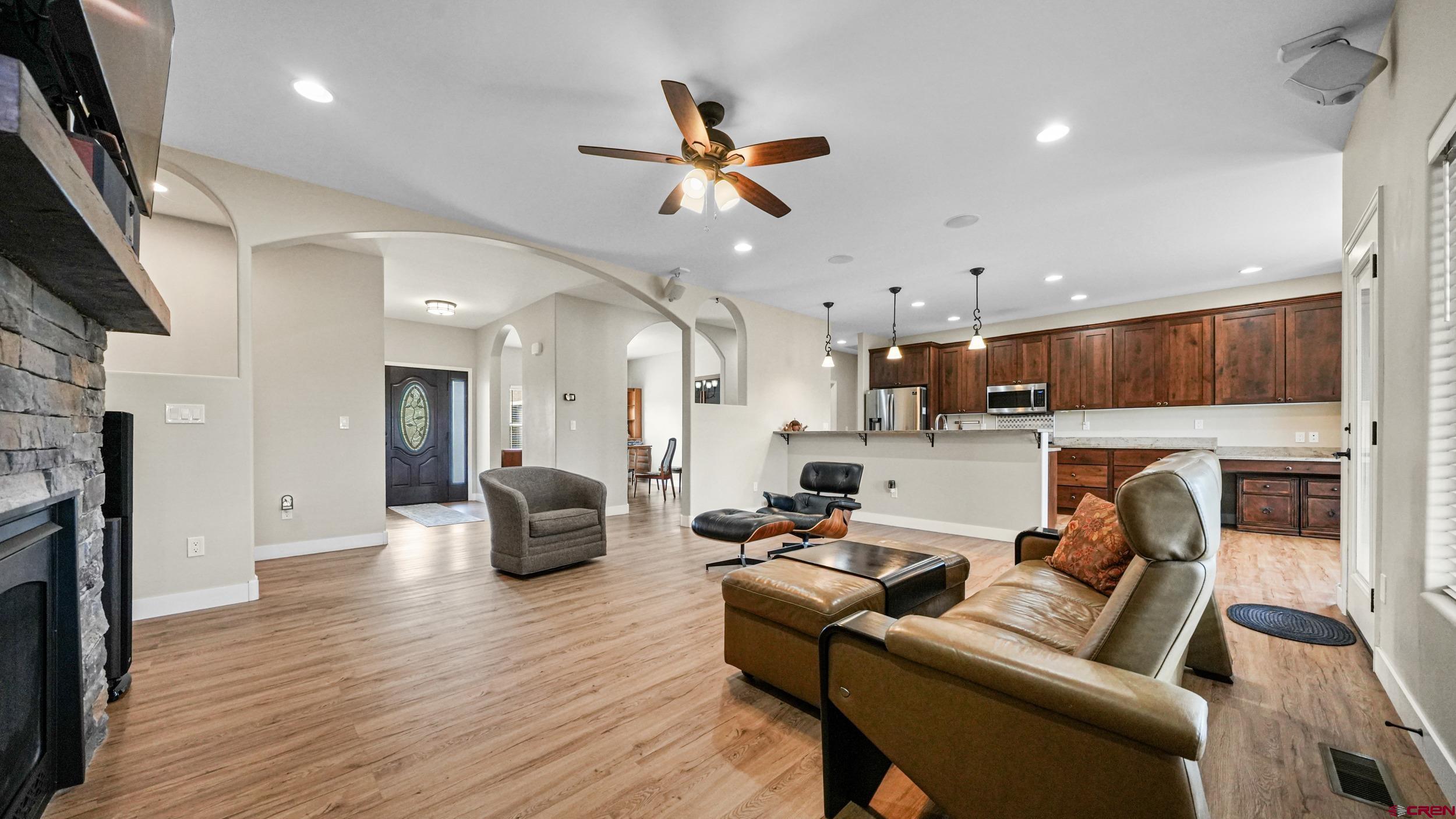 2042 Constitution Loop Montrose, CO 81401 - Photo 6 of 42 a living room with furniture kitchen view and a fireplace