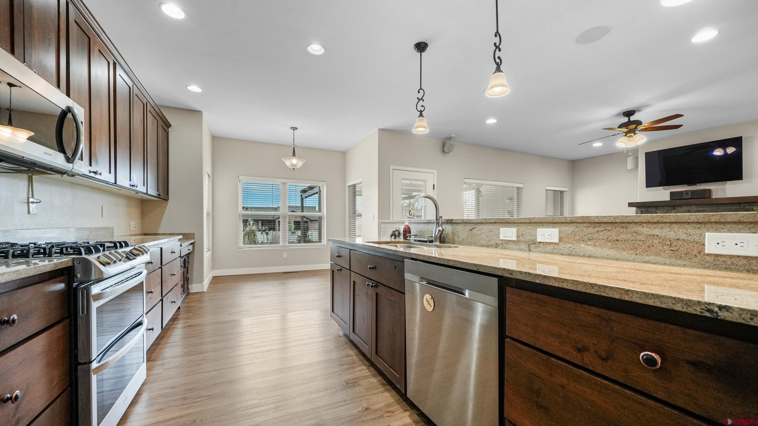 2042 Constitution Loop Montrose, CO 81401 - Photo 10 of 42 a large kitchen with stainless steel appliances granite countertop a stove and a sink