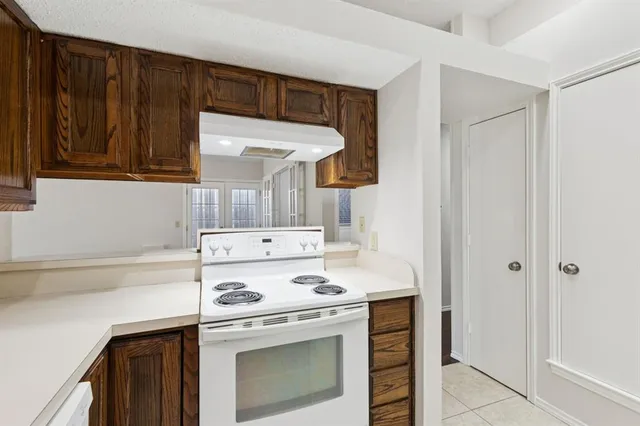 a kitchen with a stove and a refrigerator