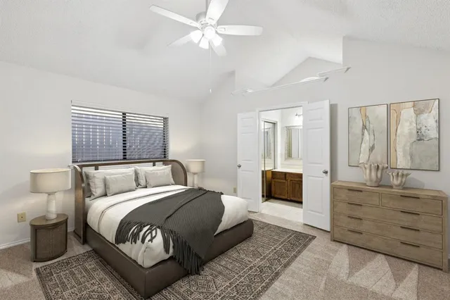 a bedroom with a large bed and a couch