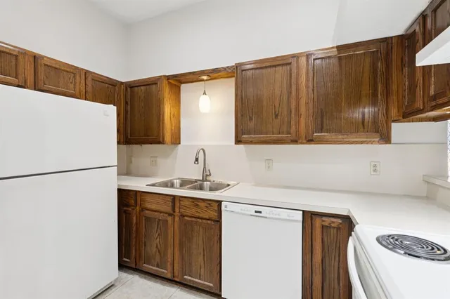 a kitchen with a sink a refrigerator and a stove