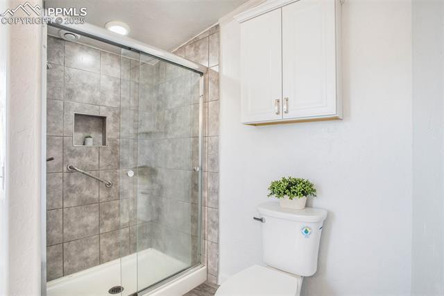 8440 Piute Road Colorado Springs, CO 80926 - Photo 17 of 34 Huge, light-filled primary bathroom featuring dual vanities and a free-standing glass shower—an elegant and spacious retreat.