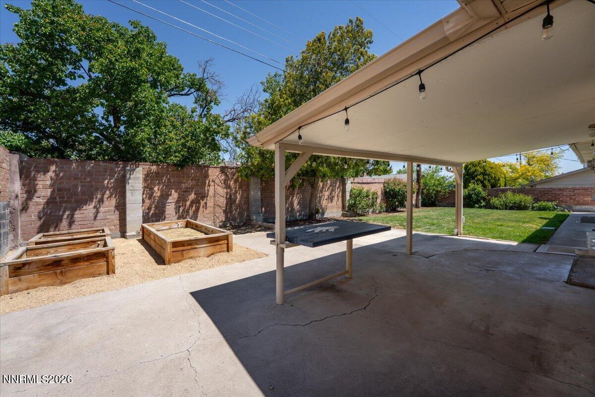 2205 Carlin Street Reno, NV 89503 - Photo 26 of 51 a view of a patio with a table and chairs under an umbrella