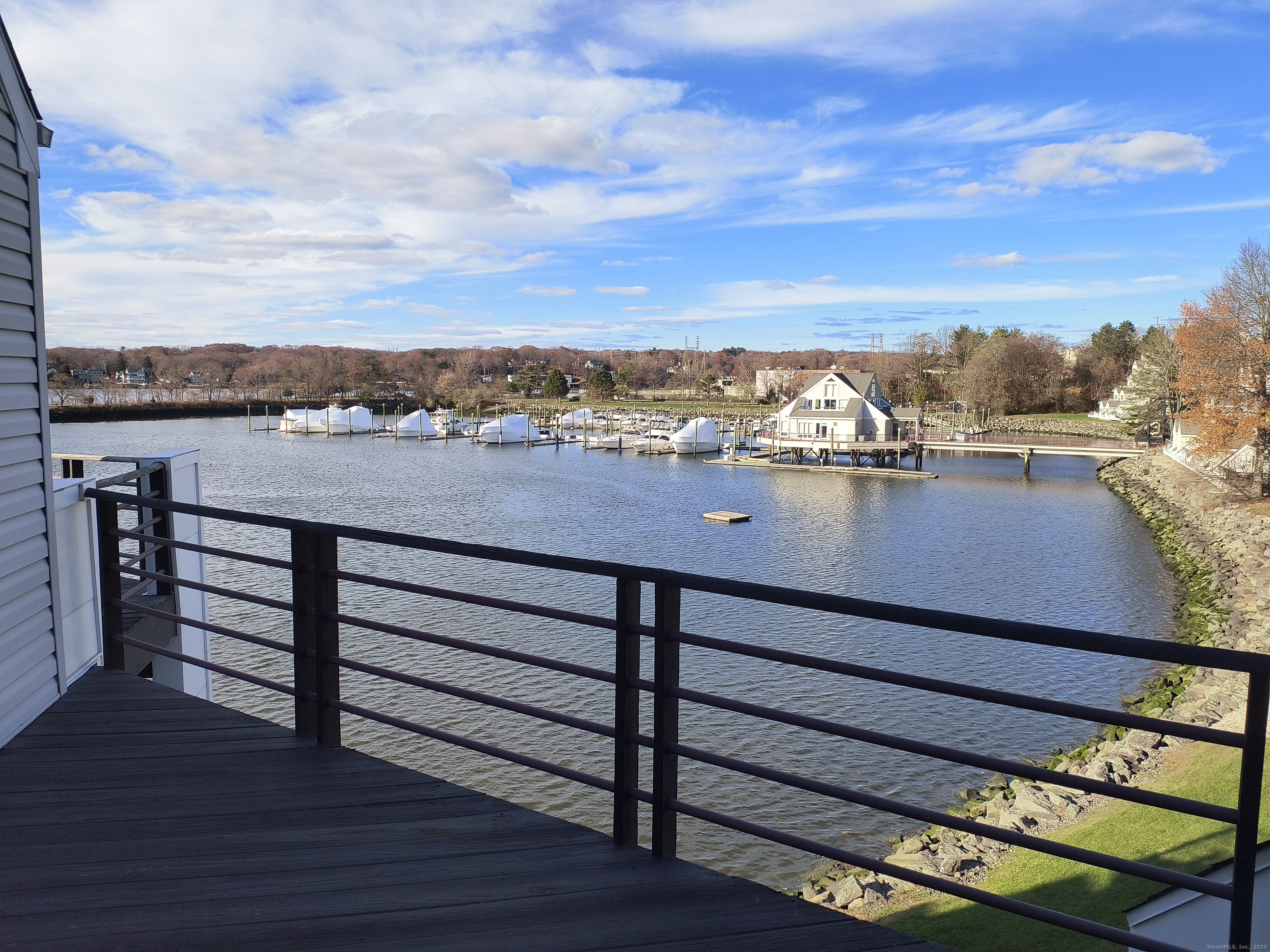 532 Popes Island Road, Unit 532 Milford, CT 06461 - Photo 11 of 23 a view of a terrace with wooden floor and a city view