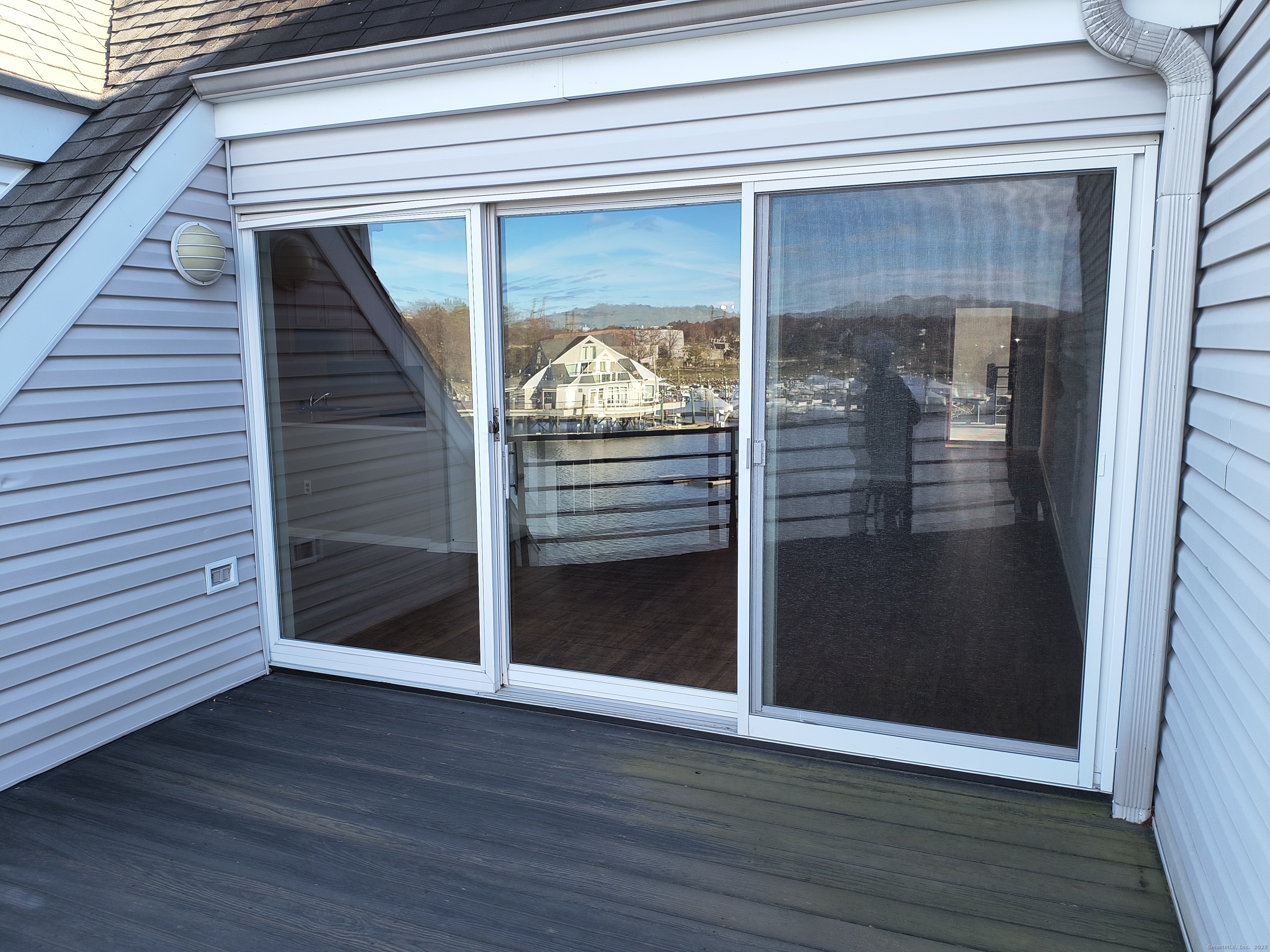 532 Popes Island Road, Unit 532 Milford, CT 06461 - Photo 12 of 23 a view of a livingroom with wooden floor and door