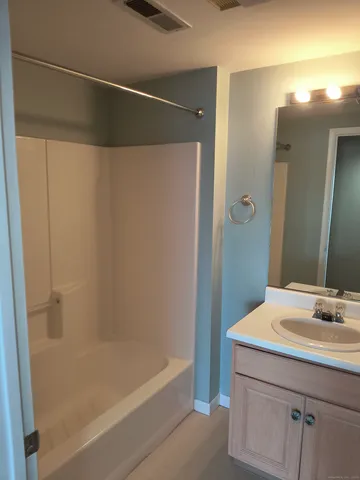a bathroom with a bathtub and a sink