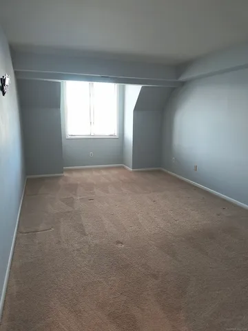 a view of an empty room and a window