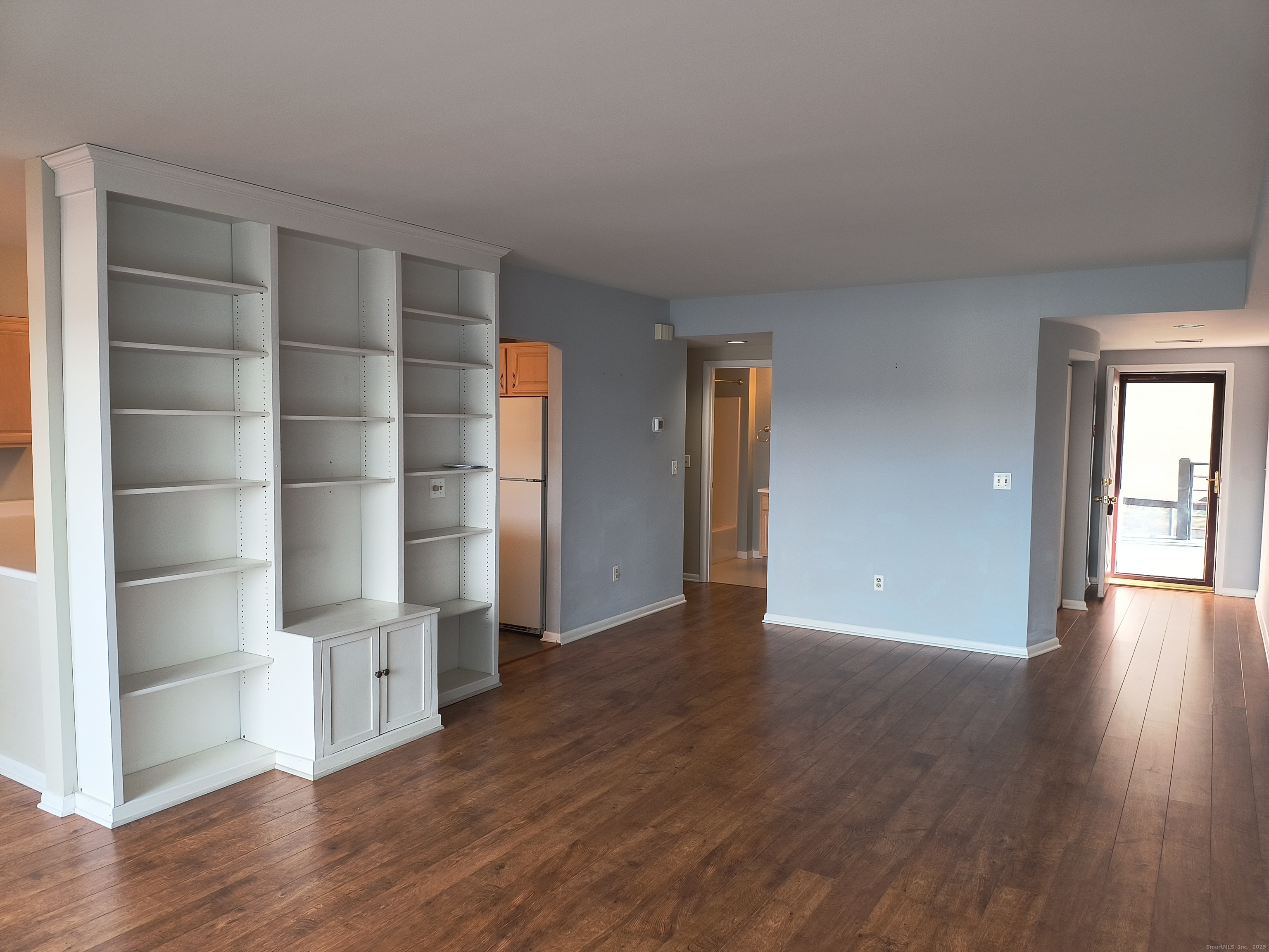 532 Popes Island Road, Unit 532 Milford, CT 06461 - Photo 4 of 23 a view of an empty room with a window and wooden floor