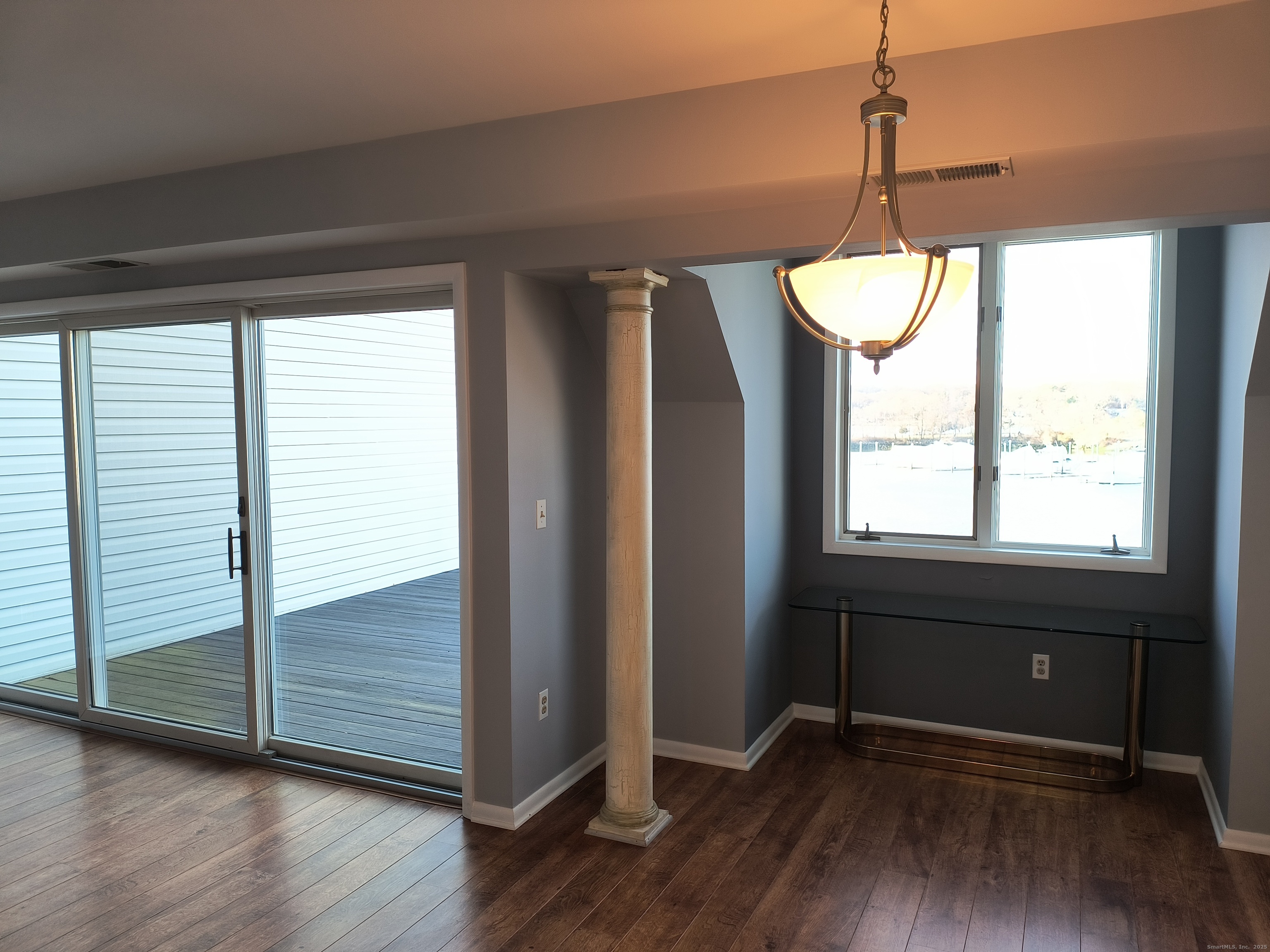 532 Popes Island Road, Unit 532 Milford, CT 06461 - Photo 7 of 23 a view of an empty room with wooden floor and a window