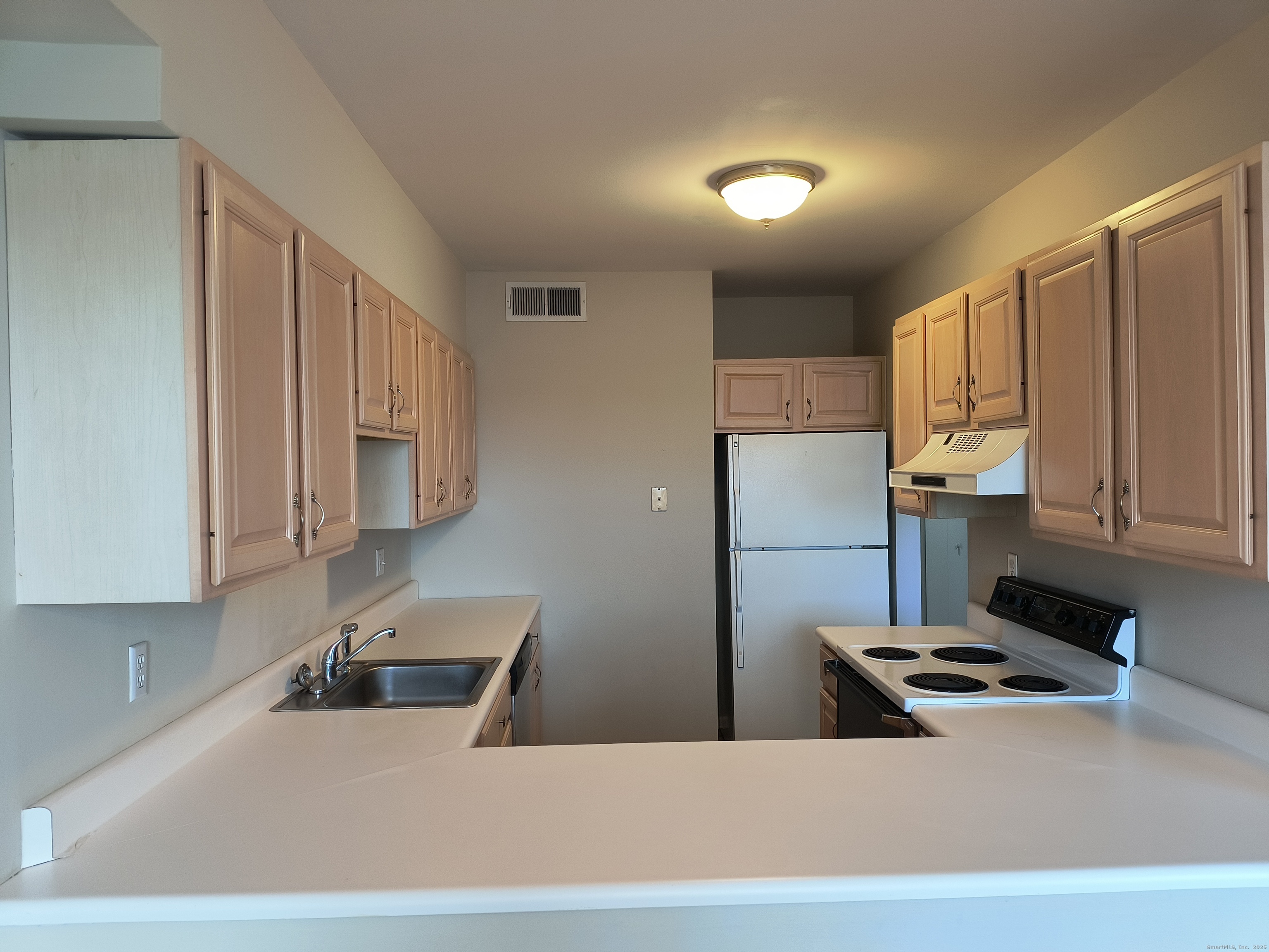 532 Popes Island Road, Unit 532 Milford, CT 06461 - Photo 8 of 23 a kitchen with stainless steel appliances granite countertop a refrigerator a stove and a sink