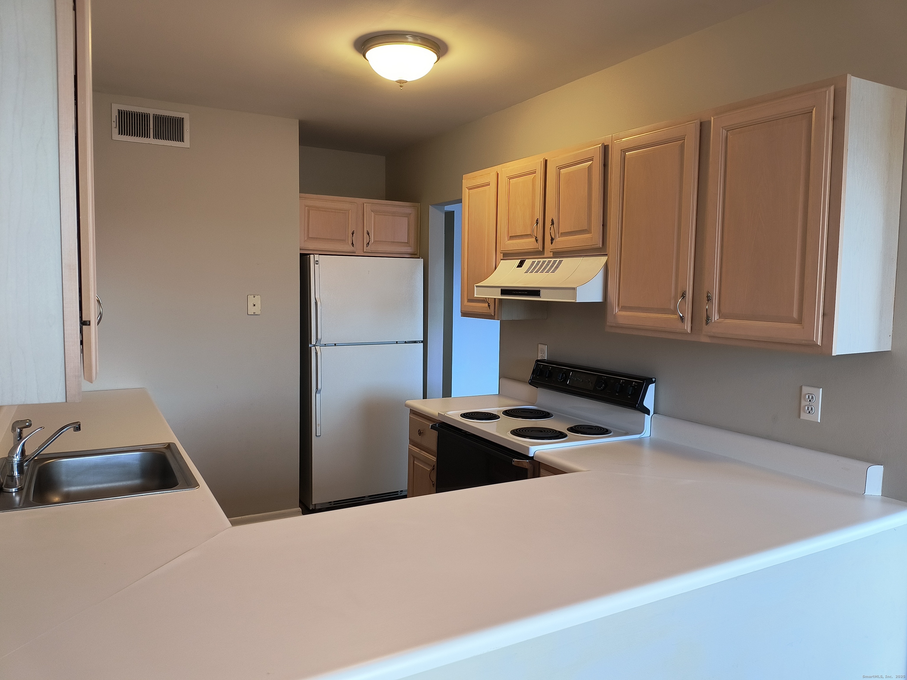 532 Popes Island Road, Unit 532 Milford, CT 06461 - Photo 10 of 23 a kitchen with stainless steel appliances a refrigerator sink and cabinets