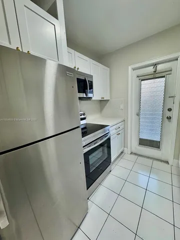 a kitchen with stainless steel appliances a refrigerator sink and microwave