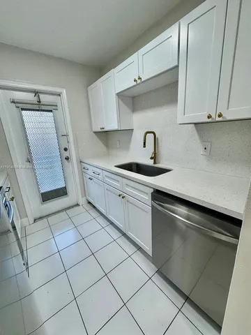 a kitchen with stainless steel appliances granite countertop a sink and a stove