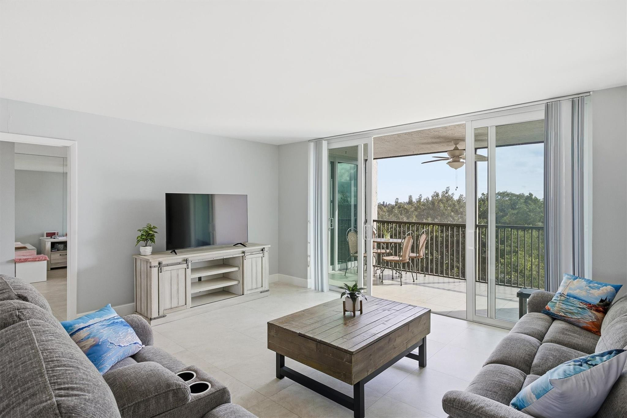 3910 Inverrary Boulevard, Unit 708B Lauderhill, FL 33319 - Photo 1 of 58 a living room with furniture a flat screen tv and a large window