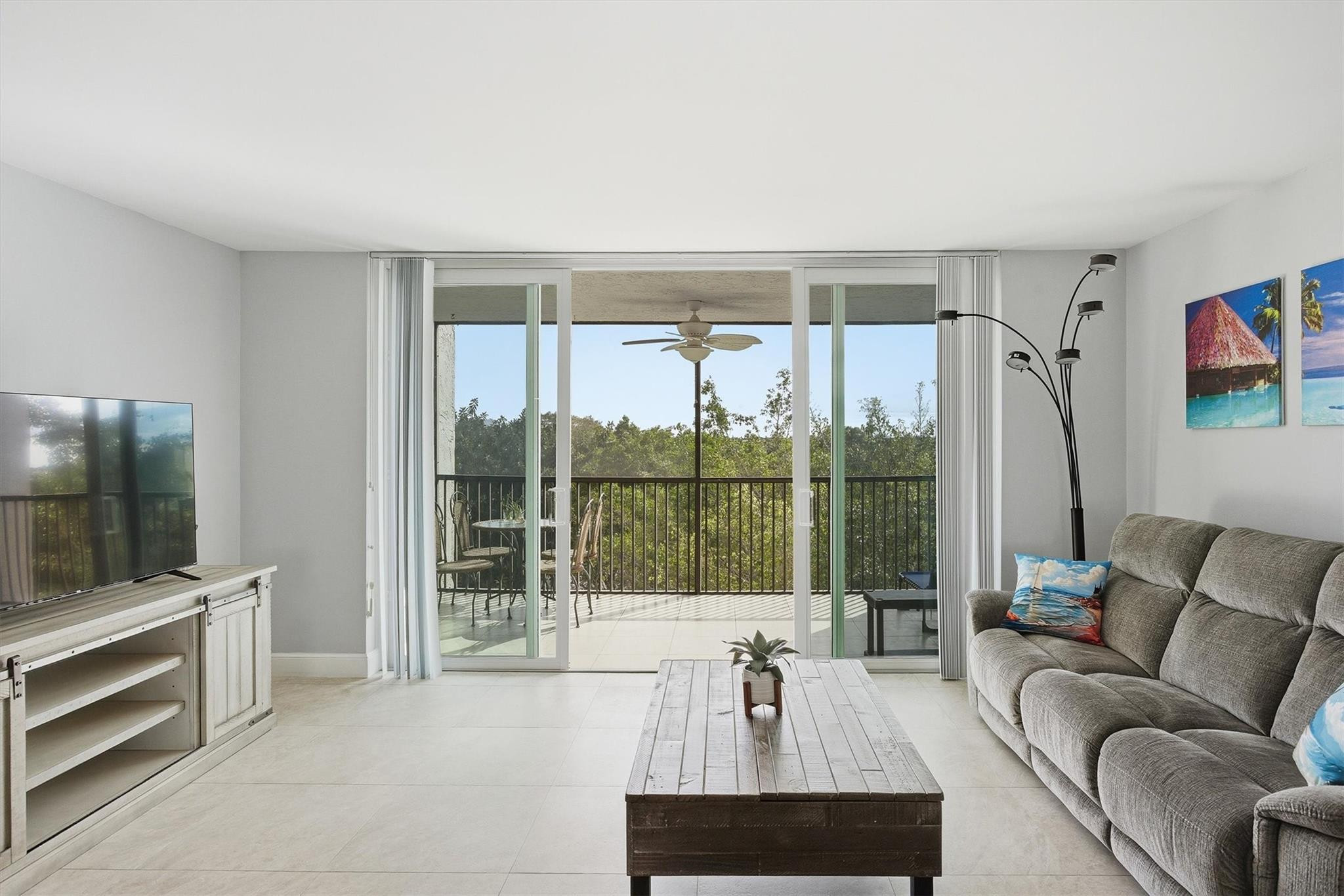 3910 Inverrary Boulevard, Unit 708B Lauderhill, FL 33319 - Photo 12 of 58 a living room with furniture and a flat screen tv